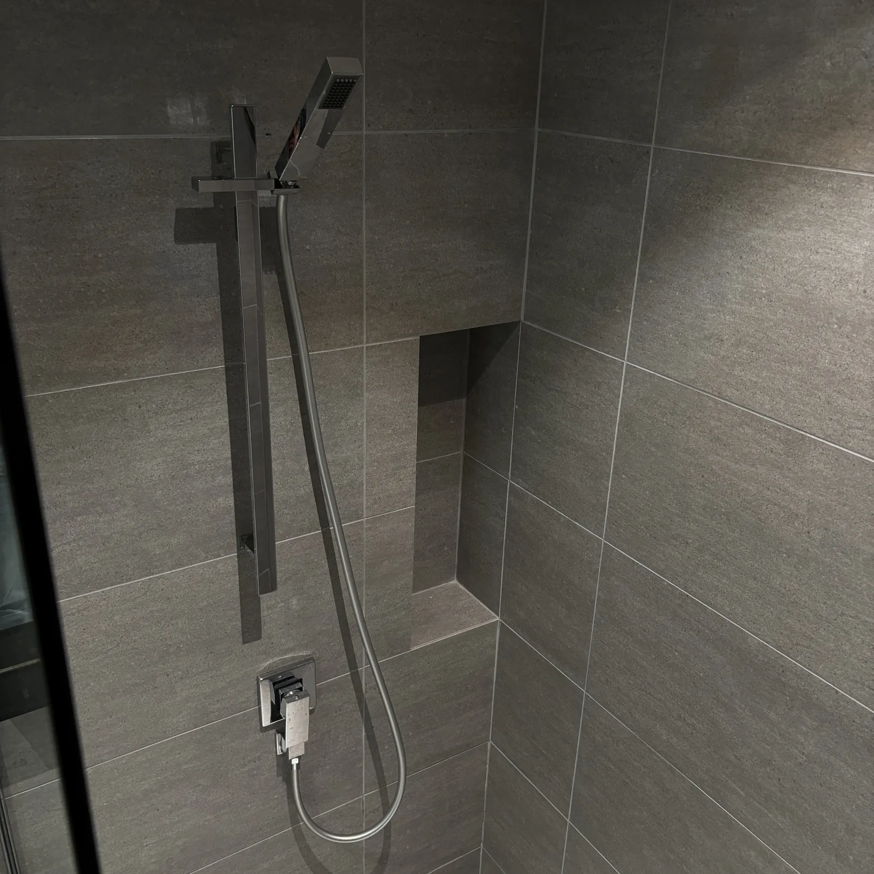 Bathroom with glass enclosure and integrated storage