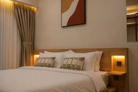 Bedroom with blackout drapery and bespoke lighting