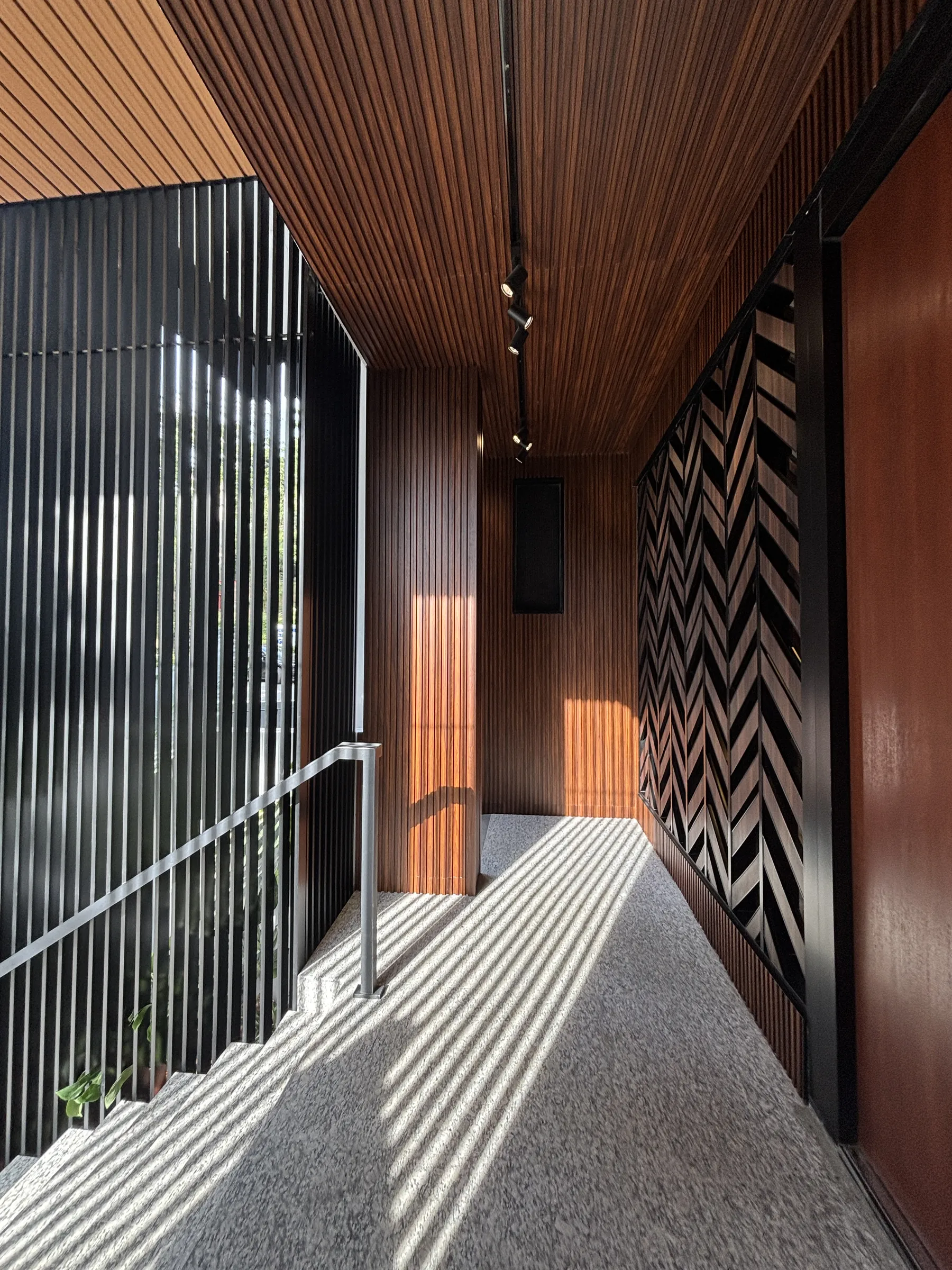 Timber-lined entrance walkway with granite floor